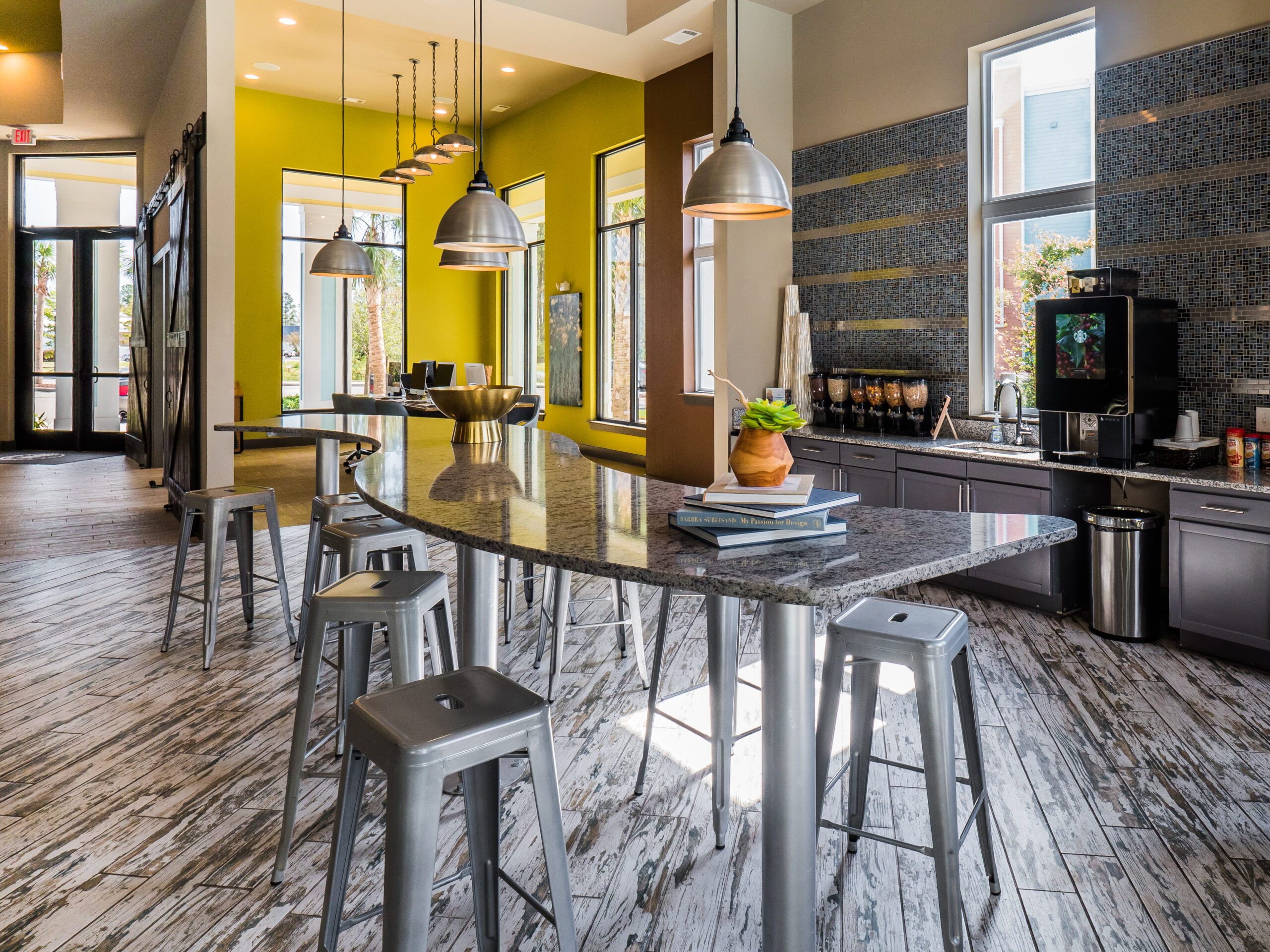 Community kitchen and seating at Progress 910, apartments near UNCW